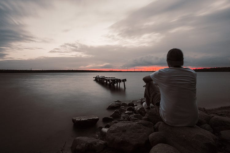 Person standing alone in nature while reflecting on personal growth and spiritual change.